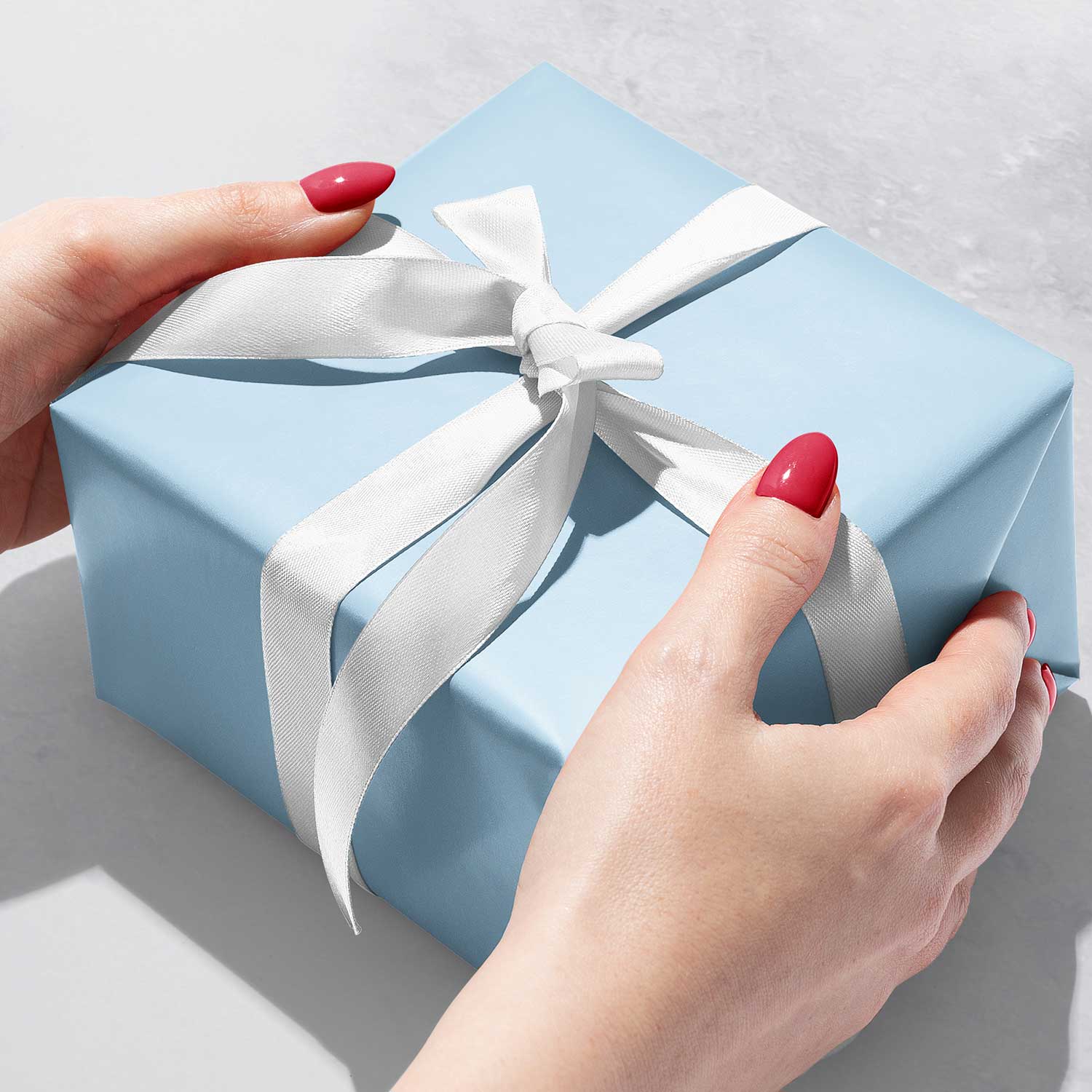 Gift wrapping presents on dark blue table. Stock Photo by ©amarosy 91746514
